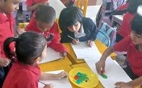 Young students painting during a classroom activity